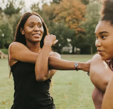 A woman exercising outdoors with others