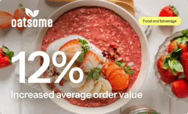 Bowl of strawberry oatmeal topped with sliced strawberries and bananas. Text: "Oatsome, 12% Increased average order value.