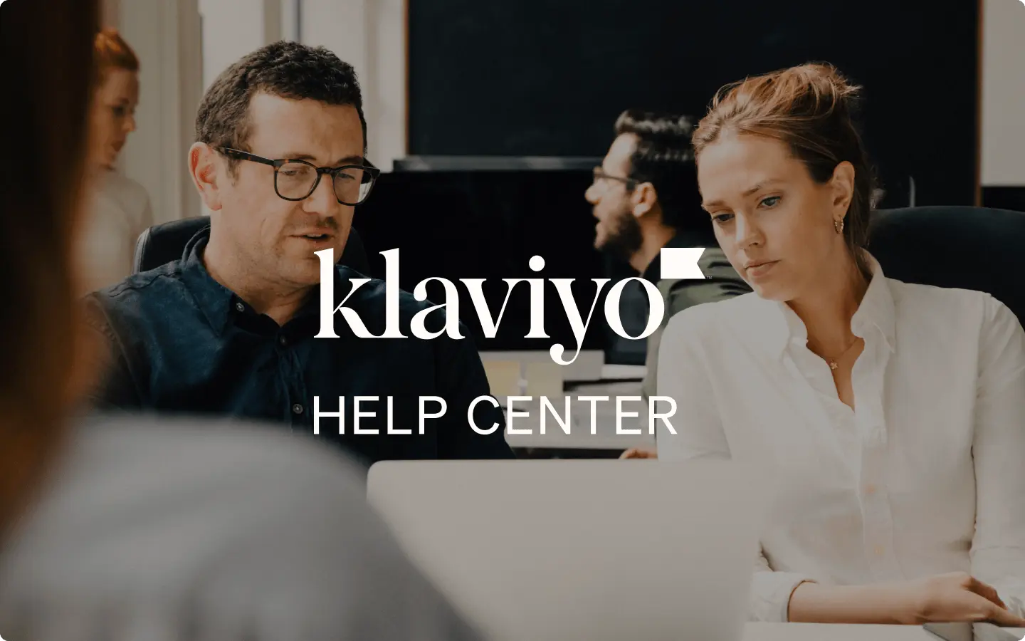 People working at computers in an office setting with "Klaviyo Help Center" text overlay.